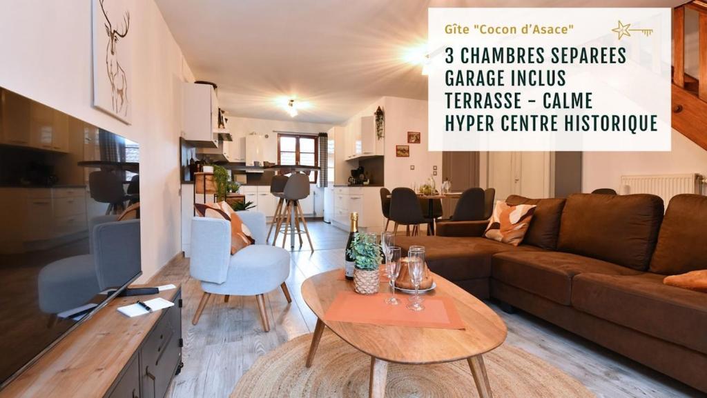 a living room with a couch and a table at Maison de ville le Cocon d Alsace - garage inclus in Ribeauvillé