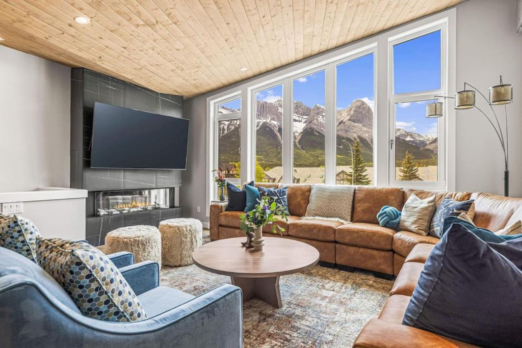 a living room with a couch and a table at Luxury 4BR with Hot Tub Mtn Views 10Min Walk to DT in Canmore