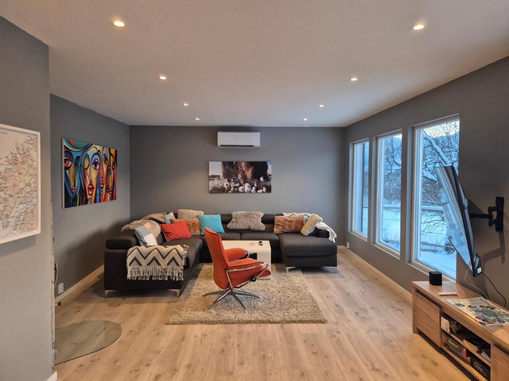a living room with a couch and a chair at Senja 4 Summit in Torsken