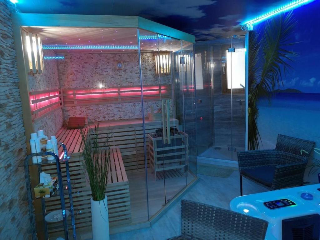 a room with a shower with benches and a table at Ferienwohnung Maaridyll In Schalkenmehren in Schalkenmehren