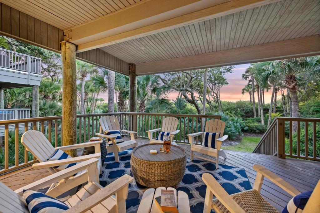 a porch with rocking chairs and a table on a deck at SS3512: 3512 Seascape in Kiawah Island