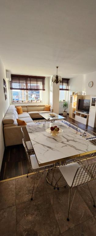 a living room with a table and a couch at Ana Apartament in Ferizaj