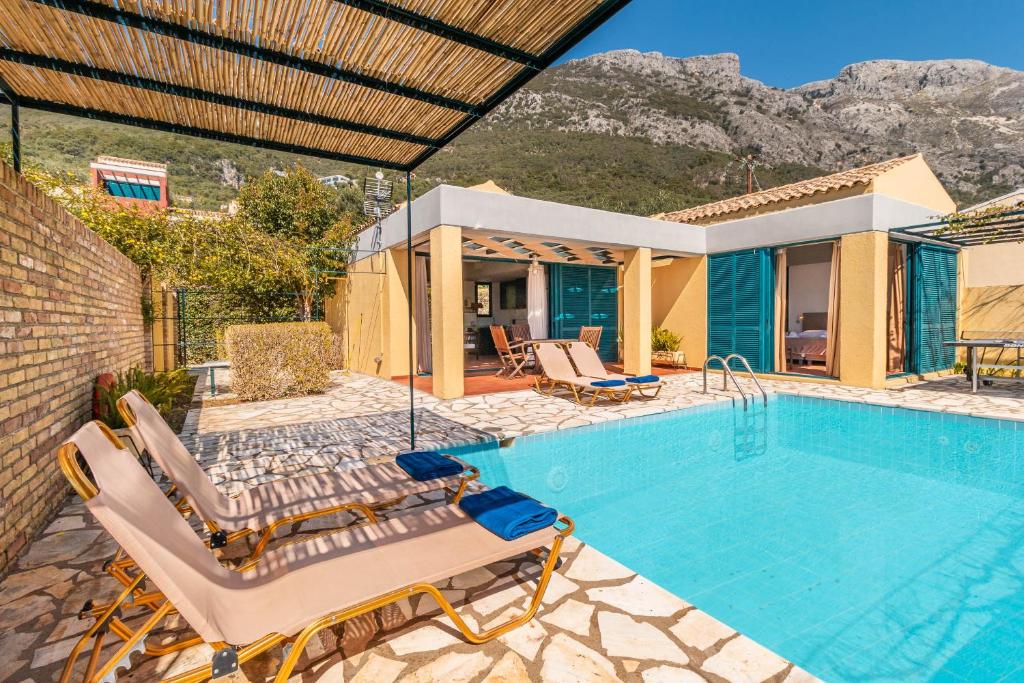 a villa with a swimming pool and a house at Barbati Beach - Villa Zante in Barbati