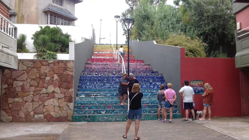 a group of people standing in front of a set of stairs at hotel monte castello II in Villa Gesell