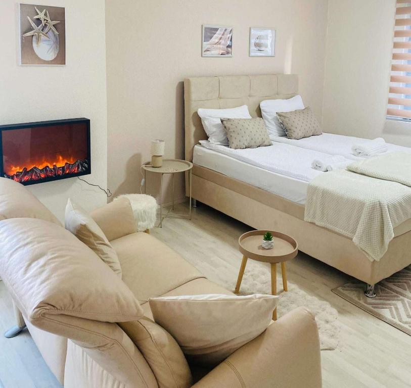 a living room with a bed and a fireplace at Apartman Safir 1 & Apartman Safir 2 & Apartman Safir 3 in Kruševac