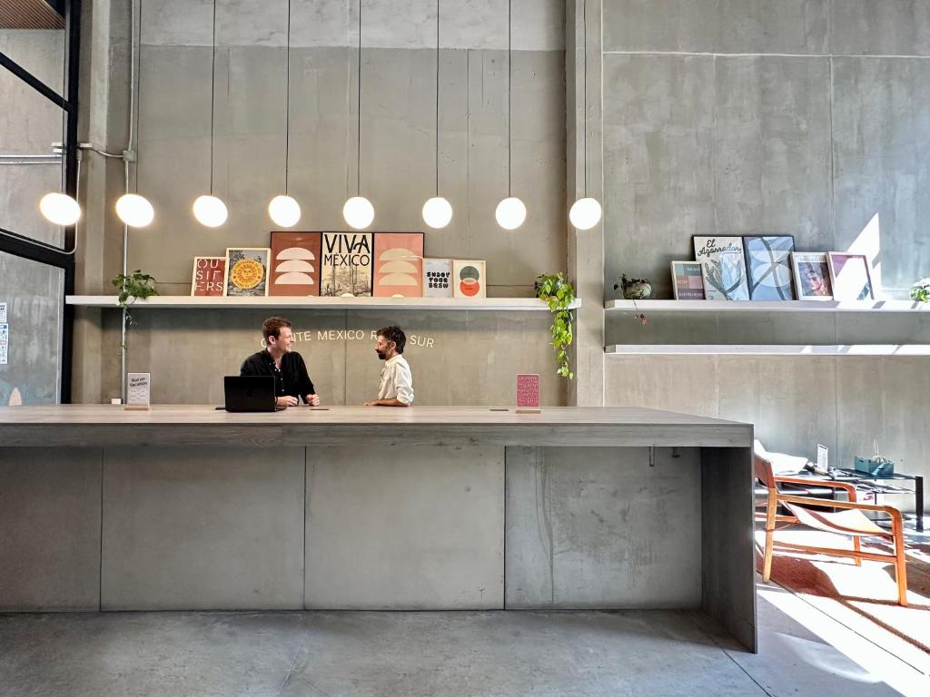 two people sitting at a desk with a laptop at Outsite Mexico City Roma Sur - Work, Connect, Explore in Mexico City