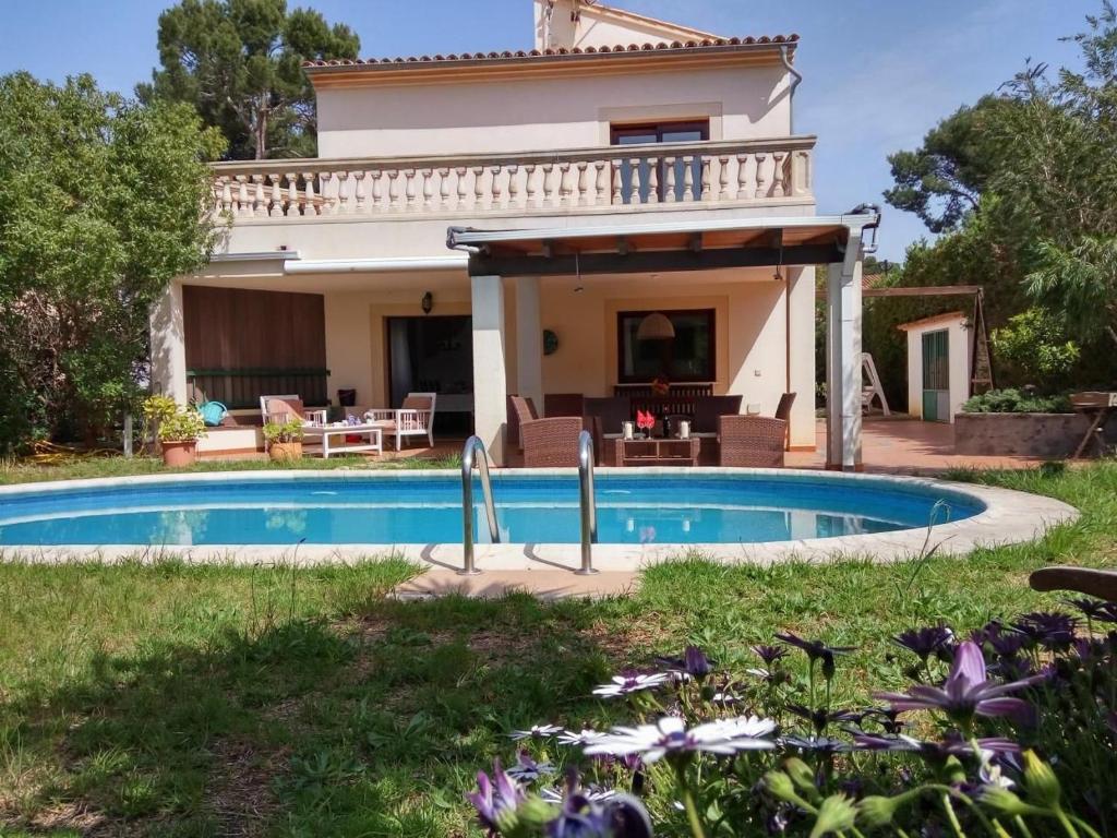 a villa with a swimming pool in front of a house at Ferienhaus In Pedruscada Mit Privatem Pool in Cala Ratjada