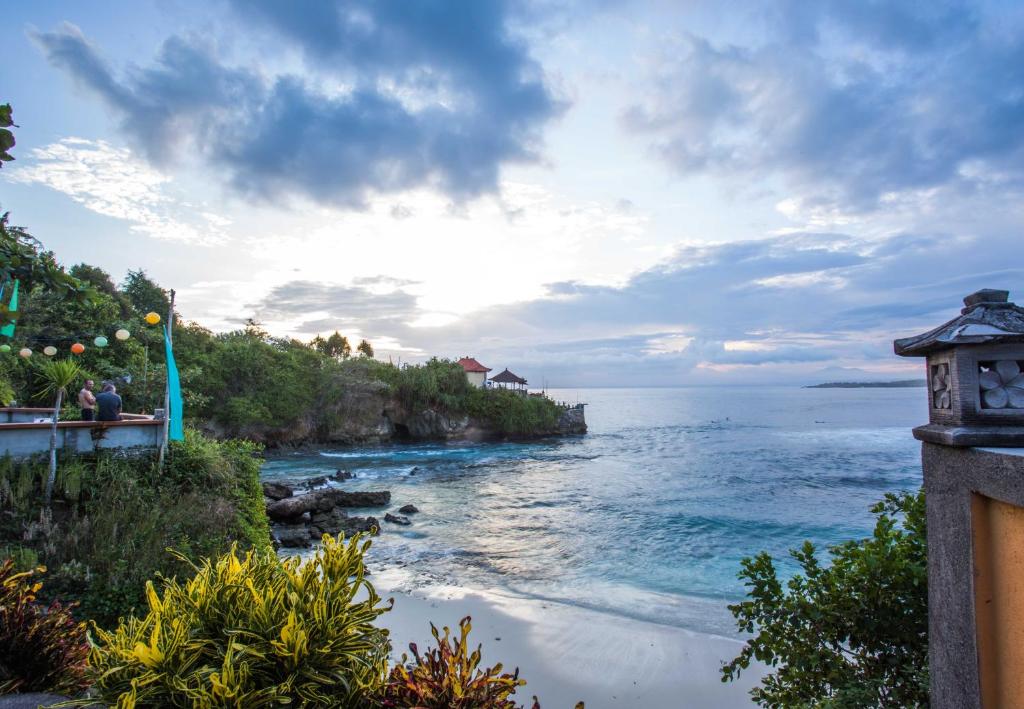 a view of a beach with the ocean at Secret Point Huts in Nusa Lembongan