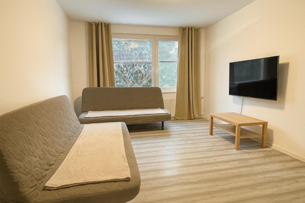 un salon avec un canapé et une télévision dans l'établissement Priestranný 3izb byt pár min od centra, à Nitra