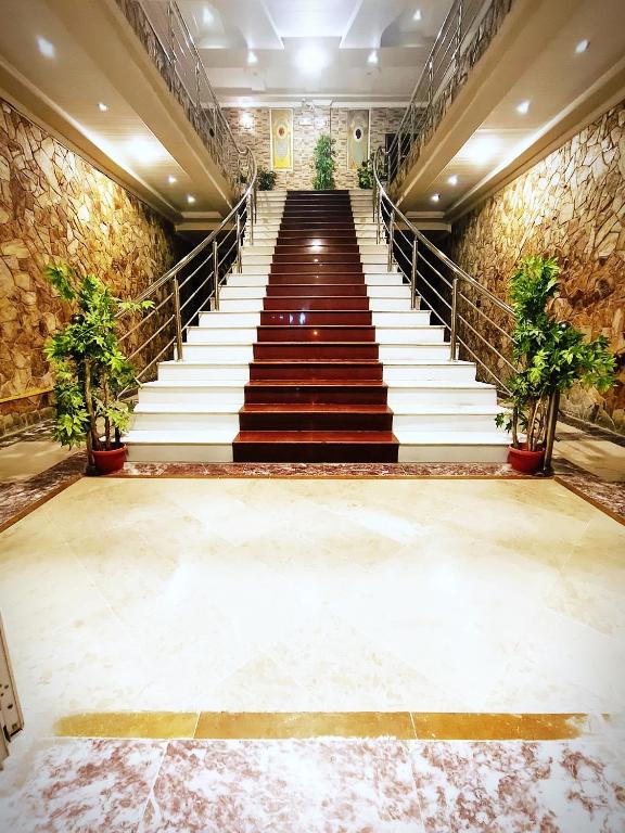 a staircase in a building with stairs and plants at Triple One Premier in Abbottabad