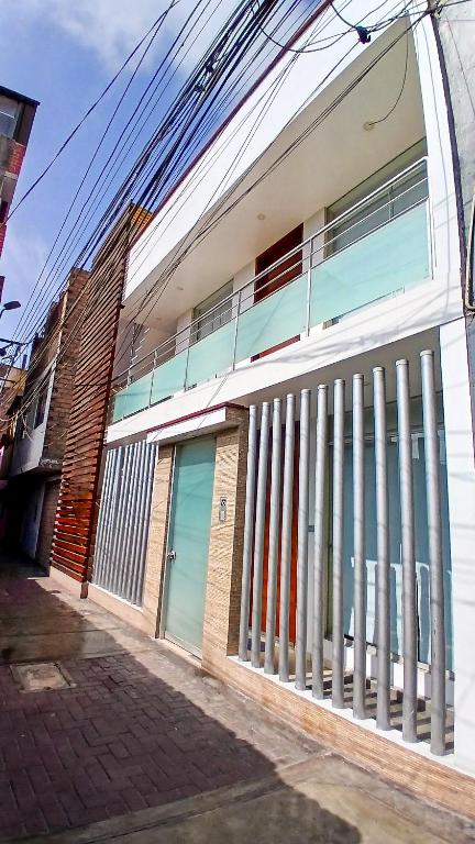 a building with a fence on the side of it at Apartamento JATUN MAMA in Chancay