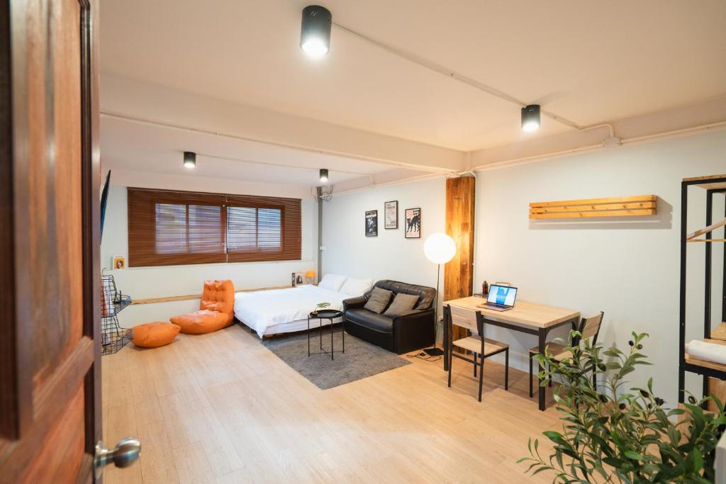 a living room with a couch and a table at Dec room at bangsue in Bang Su