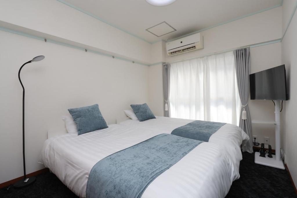 Ένα ή περισσότερα κρεβάτια σε δωμάτιο στο 森下ビル302