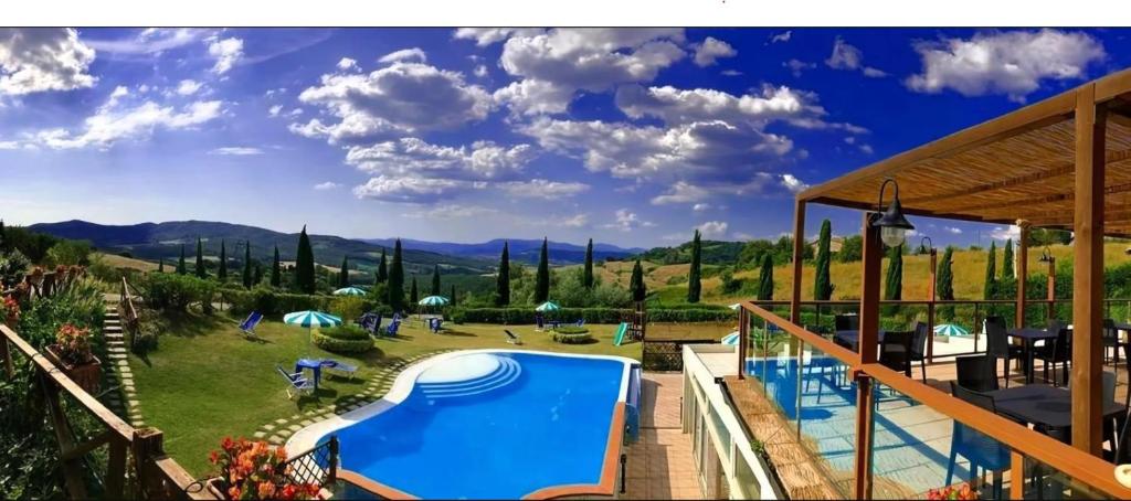 a resort with a swimming pool and a garden at Relax Hotel Acquaviva - Tuscany Hills in Lucciana