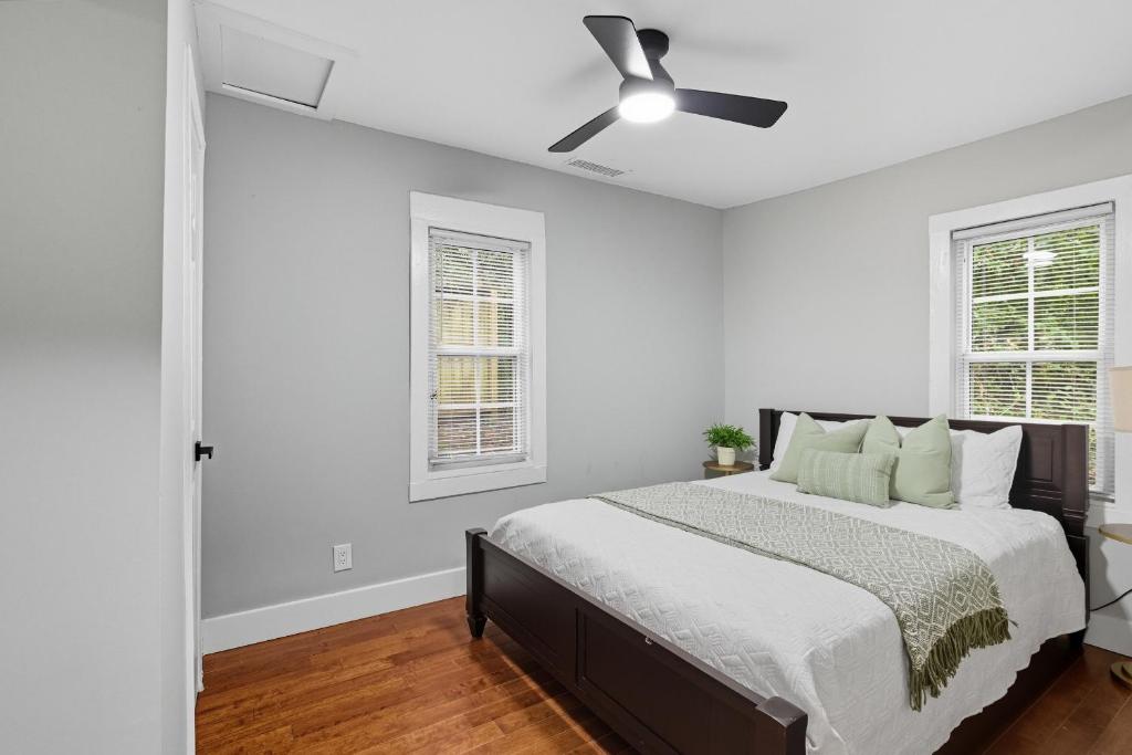 a white bedroom with a bed and a ceiling fan at Little Indale Haus - Near Downtown and Prince Ave in Athens