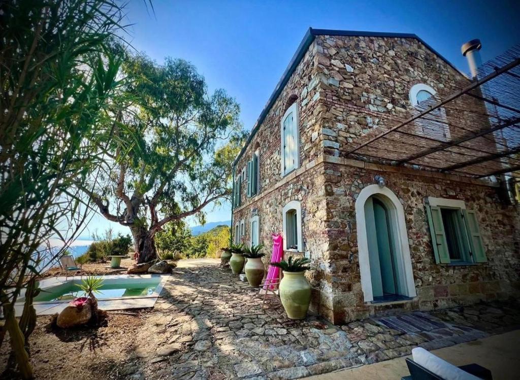 a brick house with vases in front of it at Casello 79 Rais in Finale