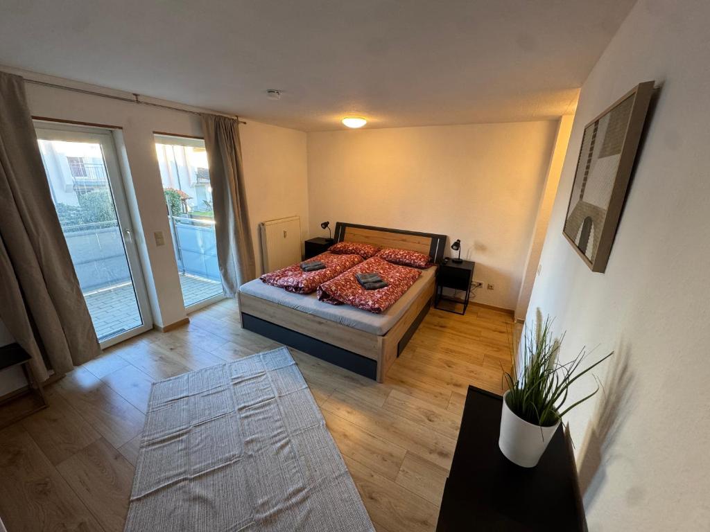 a bedroom with a bed with red pillows on it at City Apart am MUSEUM nahe BADEWELT in Sinsheim