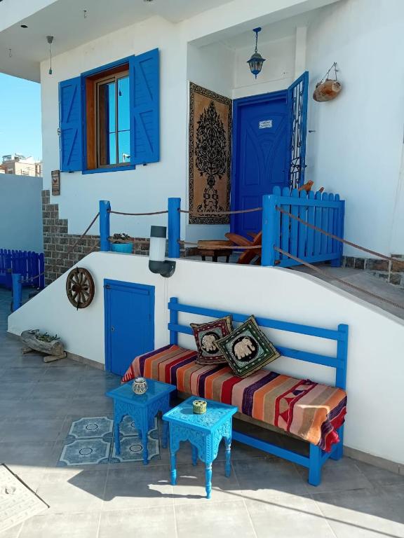 a room with blue doors and a bed and two tables at Villa Azzurra in Imsouane