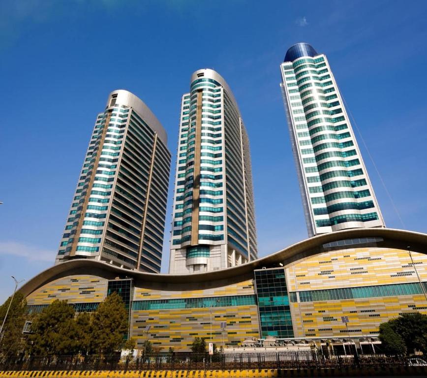 two tall skyscrapers in front of a building at One Bedroom apartment Centaurus Islamabad in Islamabad
