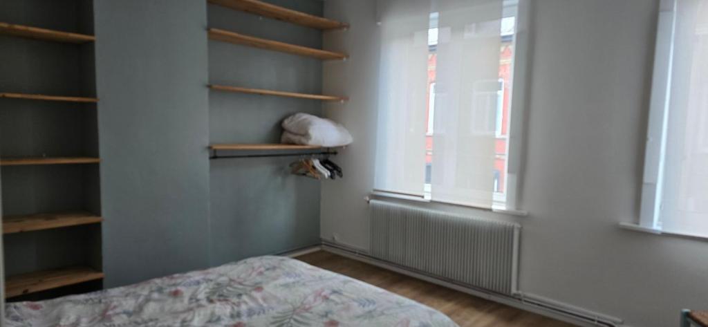 En eller flere senge i et værelse på Maison typique Nord de la France