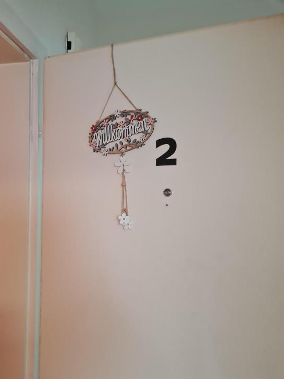 a clock hanging on a wall with the number at Zentrale, Liebevoll Eingerichtete Ferienwohnung in Monheim