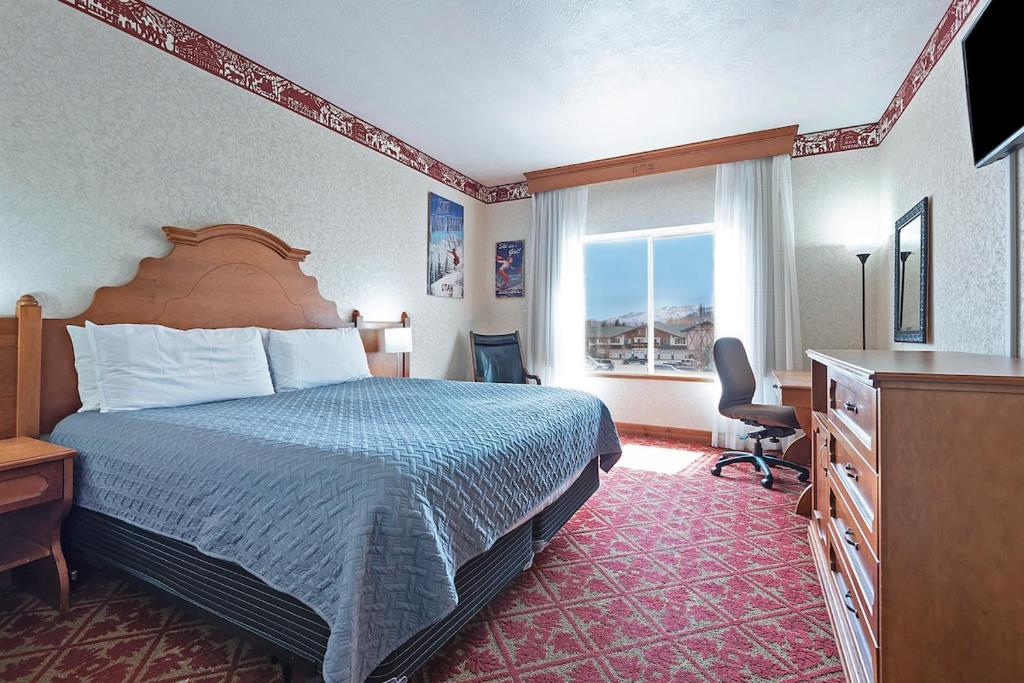 a hotel room with a bed and a desk and a window at Spacious King Suite in the Heart of Midway Near Park City & Sundance Ski Resorts - 209 in Mound City