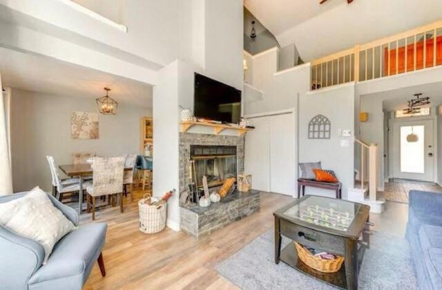 a living room with a couch and a fireplace at Lake and Ski Escape with Hot Tub Coming Soon in Lake Harmony