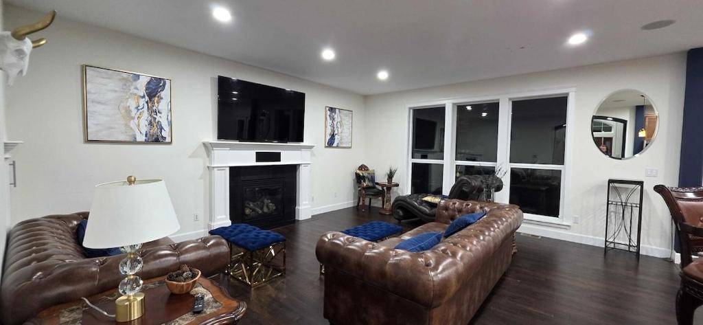 a living room with leather furniture and a fireplace at Eaglemont Golf Course Peaceful Retreat in Mount Vernon