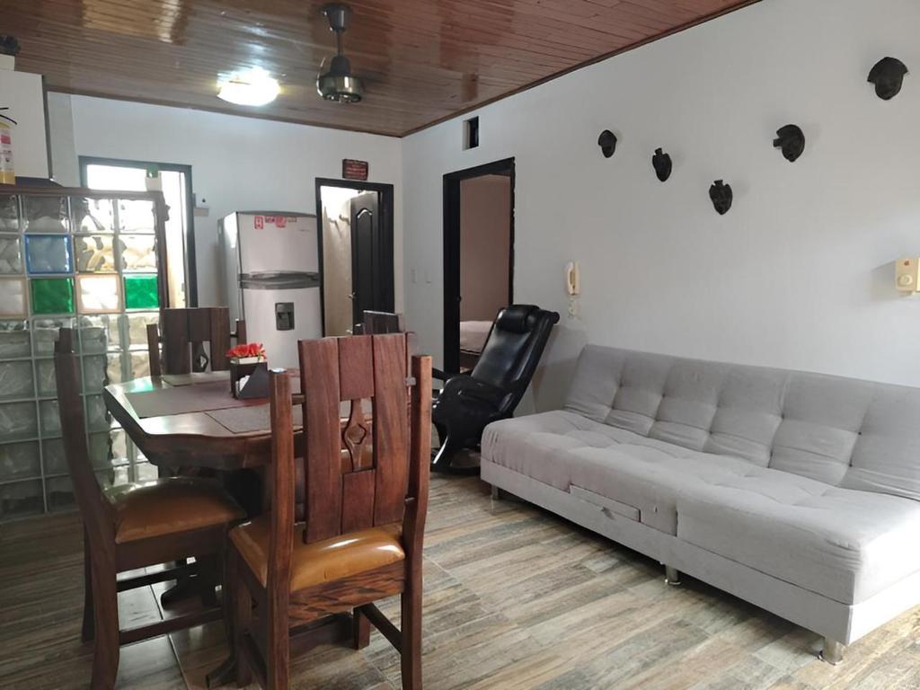 Acogedor Apto en el Rodadero في Gaira: غرفة معيشة مع أريكة بيضاء وطاولة