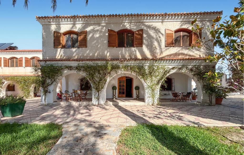 a large house with an archway in a yard at Pet Friendly Home In Elda in Almafrá