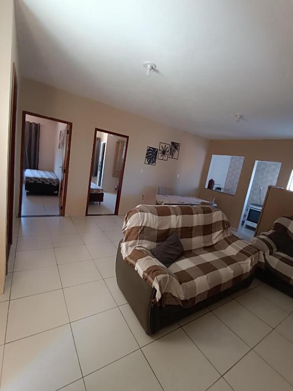 a bedroom with a bed and a couch in it at pousada Montanhez ap5 in Caparaó Velho