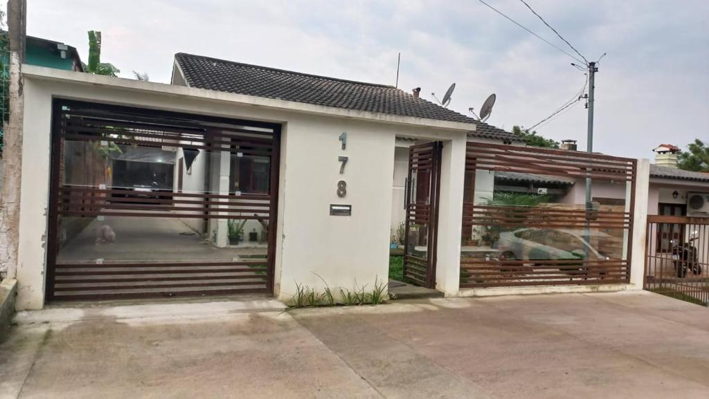 a house with two garage doors in front of it at Casa da Carmem in São Gabriel