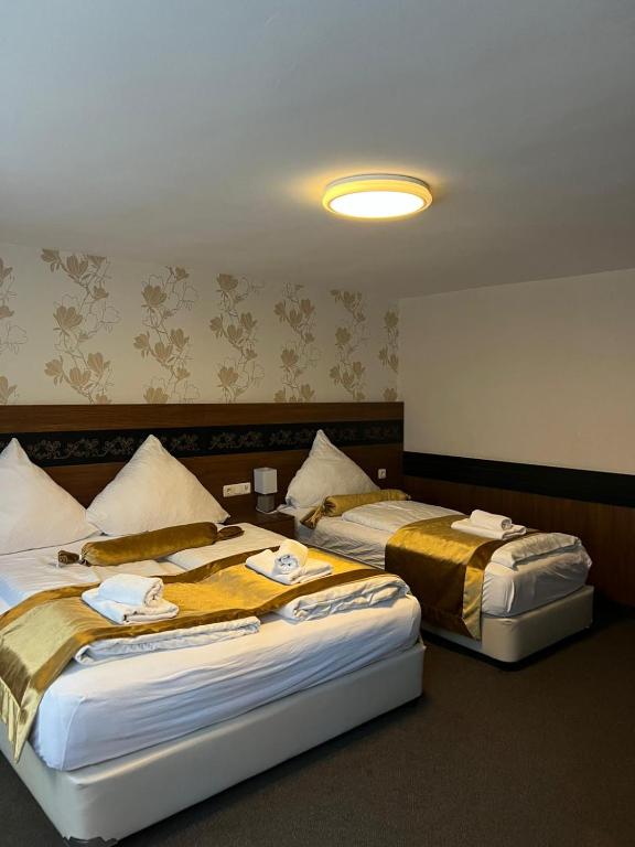 Ένα ή περισσότερα κρεβάτια σε δωμάτιο στο The Plaza Anker Hotel