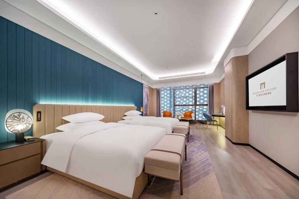 Ένα ή περισσότερα κρεβάτια σε δωμάτιο στο Jiujiang Fanglan Lake Kaiyuan Mingting Hotel