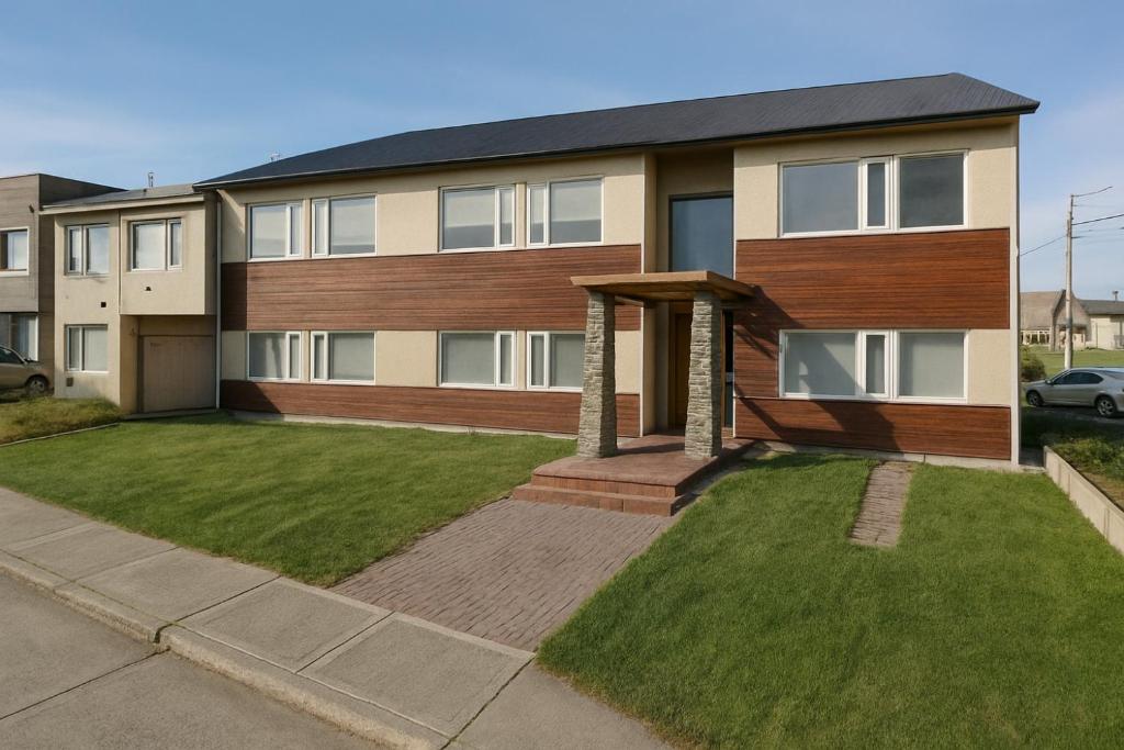 a large house with a lawn in front of it at Departamento Studio 20 - Rio Grande - Tierra del Fuego in Río Grande