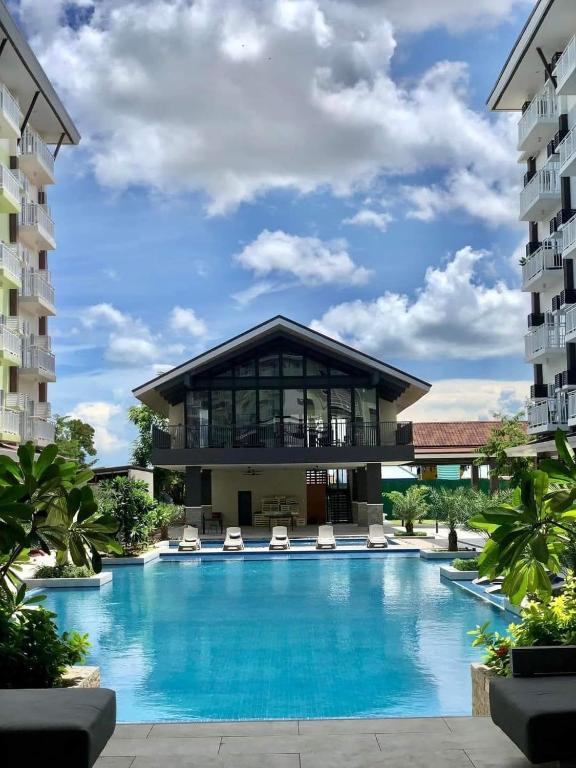 a swimming pool in front of a building at Amani Airport Haven - 726 in Pusok