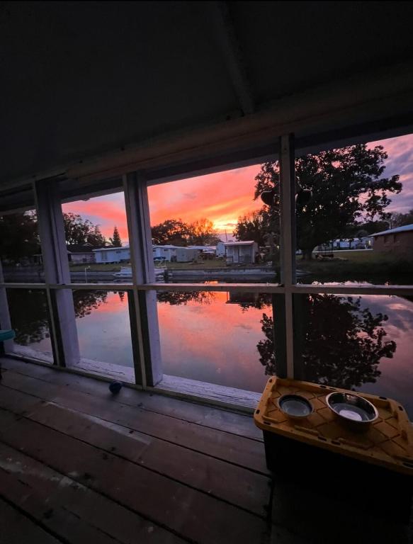 a view of a sunset seen through a window at Water front Lake House in Okeechobee