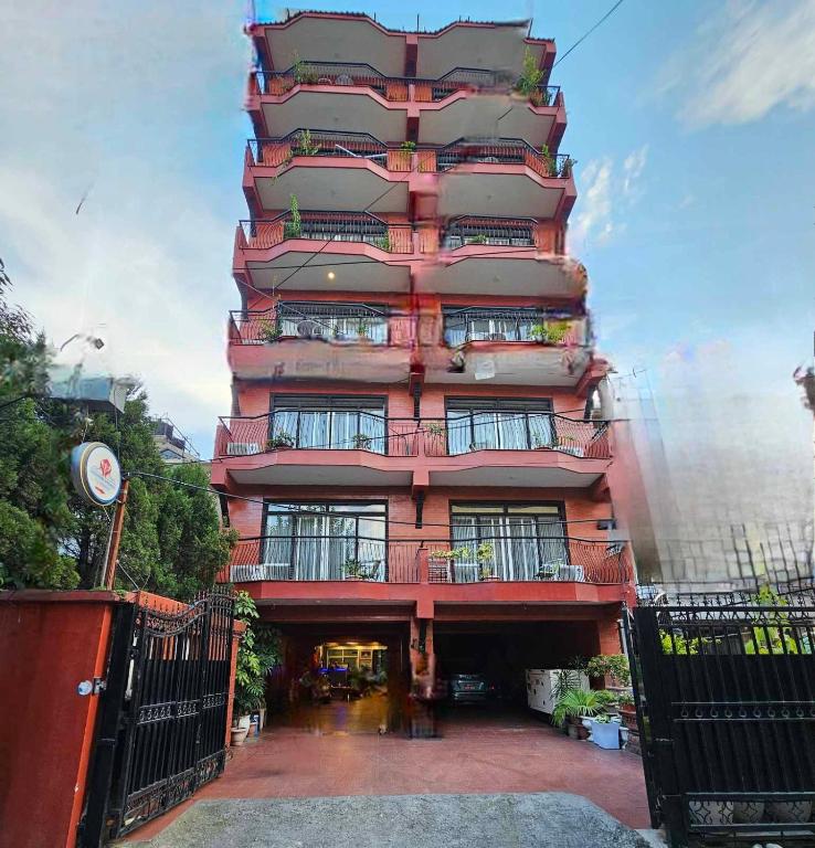 a tall building with balconies on the side of it at Sagarmatha Apartment Hotel in Pātan