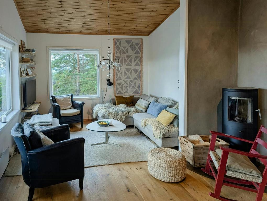 a living room with a couch and a table at Cabin With Views Of The Oslofjord On Nesodden in Nordstrand