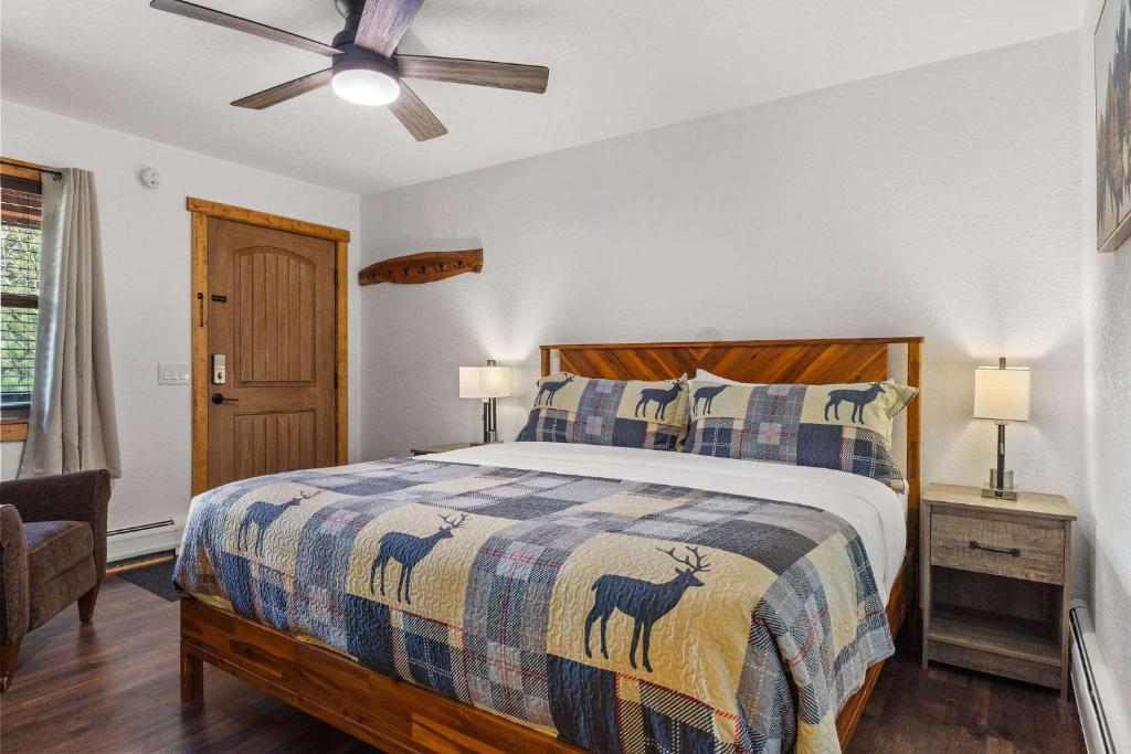 een slaapkamer met een bed en een plafondventilator bij Cabin 19- King Studio Gorgeous views Hotel Style in Estes Park