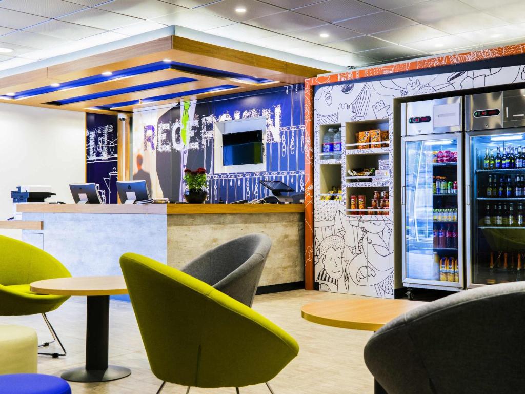 un restaurante con sillas y un bar con nevera en ibis budget Copiapo, en Copiapó