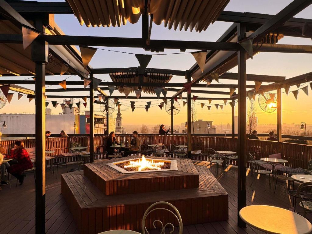 a patio with a fire pit on a deck at Mama Shelter Belgrade in Belgrade