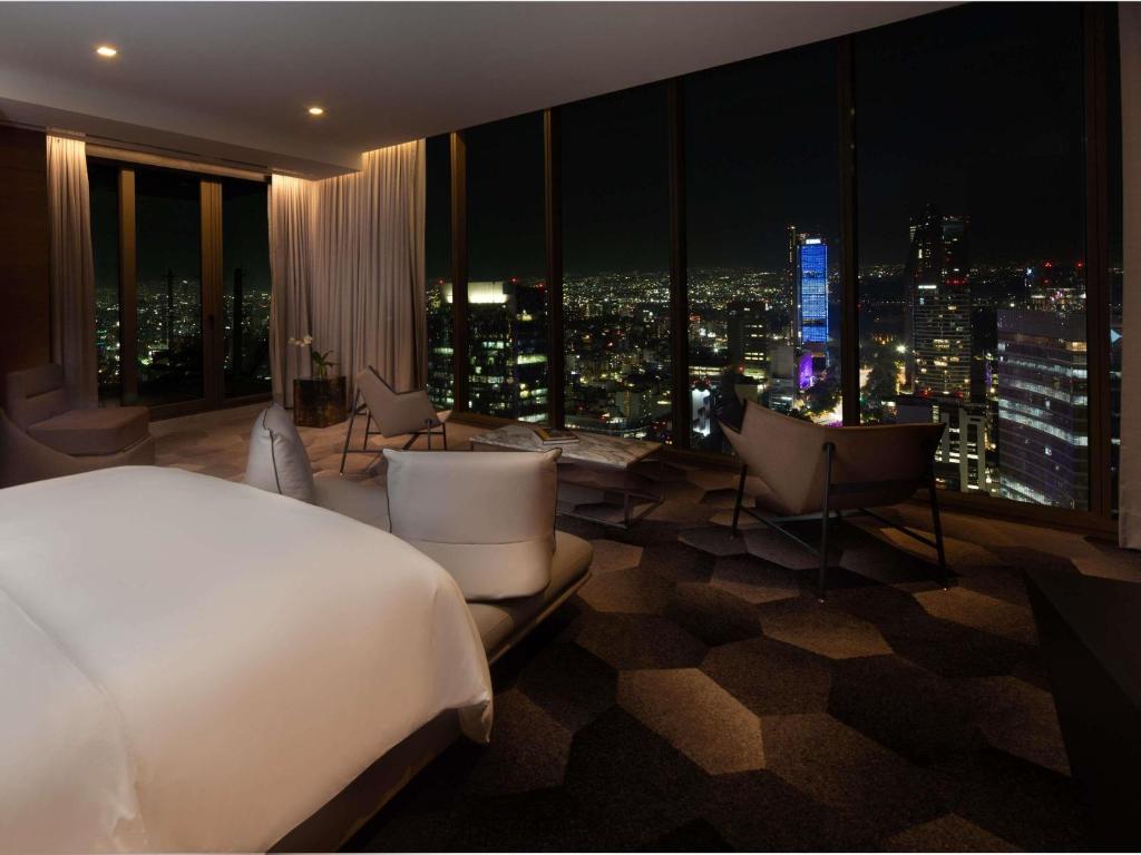 a bedroom with a bed and a view of a city at Sofitel Mexico City Reforma in Mexico City