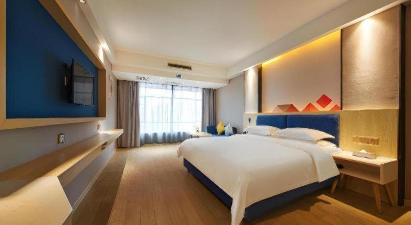 Ένα ή περισσότερα κρεβάτια σε δωμάτιο στο Borrman Hotel Liuzhou High-Speed Railway Station