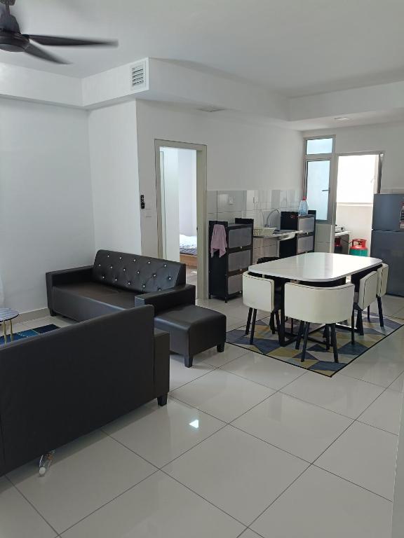 a living room with a couch and a table and chairs at Alstenor Homestay 2 in Kajang