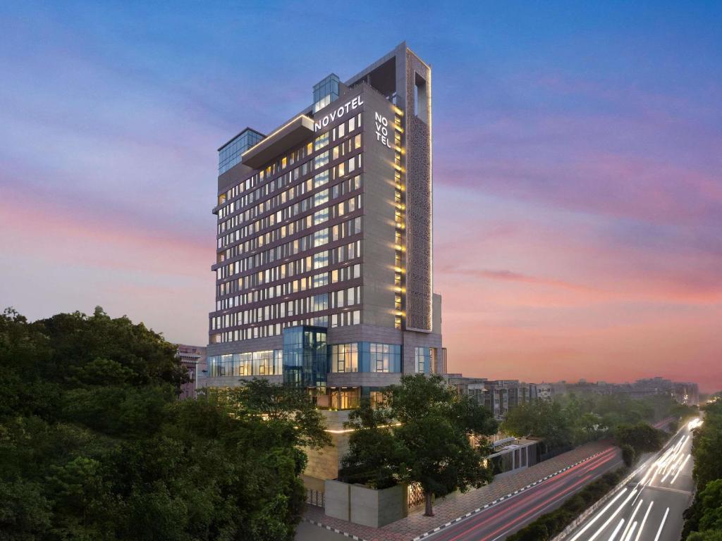 a rendering of a tall building with a train at Novotel New Delhi City Centre in New Delhi