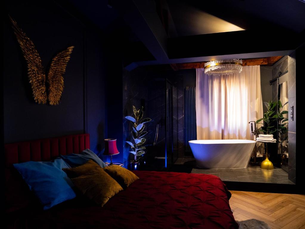 a bedroom with a bed and a bath tub in a room at Apartament Plac Zabaw in Łódź