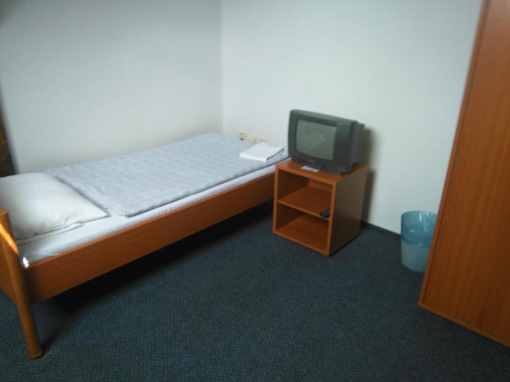 Postel nebo postele na pokoji v ubytování Penzion U Madony