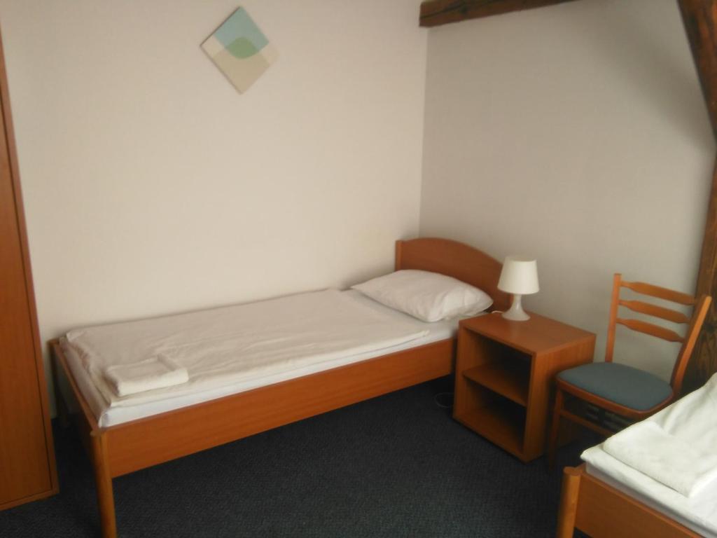 Postel nebo postele na pokoji v ubytování Penzion U Madony