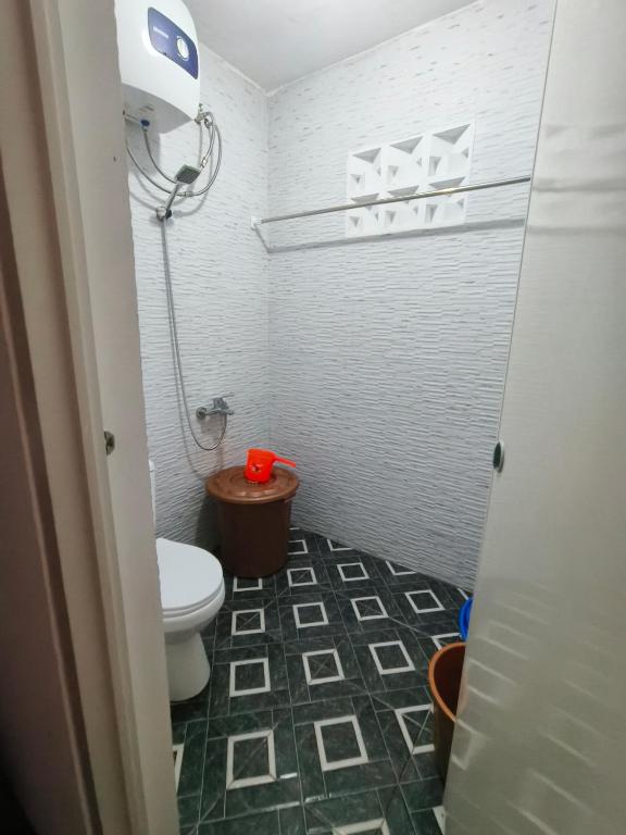 a small bathroom with a toilet and a shower at Kira Villa in Tlekung
